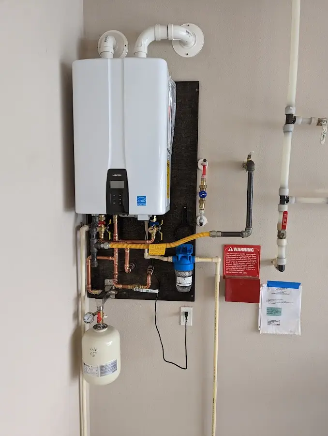 Professional plumber installing copper piping in a Princeton home